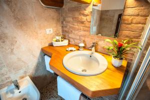 a bathroom with a white sink and a mirror at Brick House Silea in Silea +37 photos