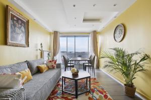 a living room with a couch and a table at Spacious and comfortable apart with parking in Colombes
