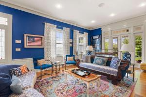 a living room with blue walls and furniture at Luxurious Estate Private Heated pool in Harwich