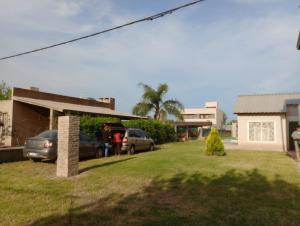 a house with cars parked in a yard at Capibara Matero in Roldán +6 photos