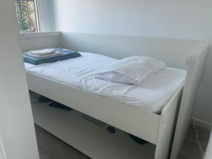 a small bed in a room with a window at Canyelles BBQ Apartment in Lloret de Mar