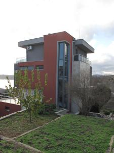 a modern house with a garden in front of it at The Beach House in Sozopol