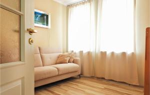a living room with a couch in front of a window at Cozy Apartment In Kolobrzeg With Wifi in Kołobrzeg
