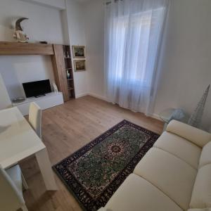 a living room with a white couch and a table at Residence Bambocci in Frascati