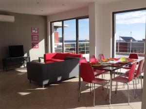 a living room with a couch and a table and chairs at The Beach House in Sozopol