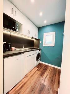 a kitchen with a sink and a washing machine at 70 steps studio A, 50 meters from Dimokratias metro station in Thessaloniki +13 photos