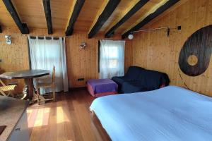 a bedroom with a bed and a desk and a table at TAO casa WOOD apartamentos in Olot