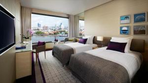 Postel nebo postele na pokoji v ubytování Avani Plus Riverside Bangkok Hotel + 37 fotografií