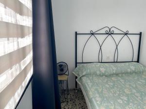 a bedroom with a bed with a metal frame at Centrico Atico Apt Sleeps 4 with Patio in Almuñécar