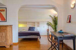 a bedroom with a bed and a desk in a room at l'hacienda in Ustaritz +18 photos