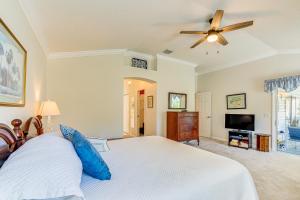 a bedroom with a bed and a ceiling fan at Walk to Golf and Pool Pet-Friendly Villages Home in The Villages +26 photos