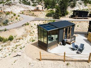 a glass house on the side of a mountain at Hidden Abode in Orderville