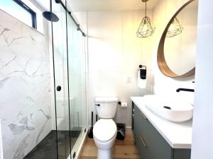 a bathroom with a toilet and a sink and a mirror at Valley View in Orderville +8 photos