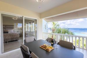 a dining room with a table and a view of the ocean at Blue Emerald at Blue Bay Beach & Golf Resort in Sint Michiel +31 photos