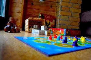 a table with a board game and toys on it at Harcsási 60 Vendégház in Békésszentandrás
