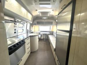 an rv kitchen with a sink and a refrigerator at Airstream Adventure in Orderville