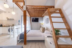 a loft bed with a ladder in a bedroom at Oli by Unik Vacation in Tarragona