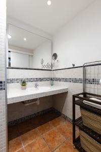 a bathroom with a sink and a large mirror at Oli by Unik Vacation in Tarragona +39 photos