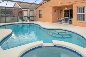 a pool at a resort with chairs and tables at Upstay Lakeside Retreat w Private Pool and Game Room in Davenport +22 photos