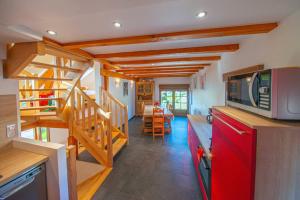 a kitchen with a red refrigerator and a staircase at Le chalet Montanea-Jacuzzi-Free parking in Ventron +30 photos