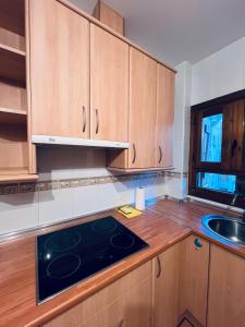 a kitchen with wooden cabinets and a stove top oven at Apartamento Espata VII in Villanúa +7 photos
