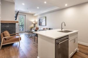 a kitchen with a sink and a counter top at New 1Bd Luxe King Suite with Superb Mtn View in Canmore