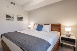 a bedroom with a large bed and two lamps at New 1Bd Luxe King Suite with Superb Mtn View in Canmore