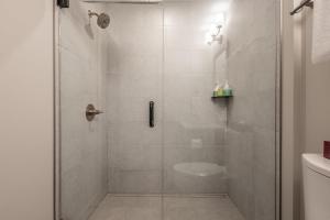 a bathroom with a shower with a glass door at New 1Bd Luxe King Suite with Superb Mtn View in Canmore