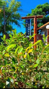 a bush with a sign in front of a house at Departamento Monoambiente 3 Del Sauce in Paraná