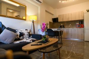a living room with a couch and a table and a kitchen at Neria 1 in Alexandroupoli