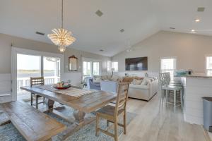 a dining room and living room with a table and chairs at Private Hot Tub and Dock North Topsail Beach Home in North Topsail Beach