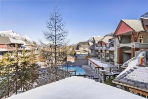 a view from the balcony of a resort in the snow at Freshly Remodeled - 2 King Beds- Breathtaking Views in Canmore +40 photos