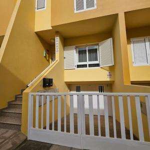 a building with a white railing and a staircase at Casa Criso Puerto del Rosario in Puerto del Rosario