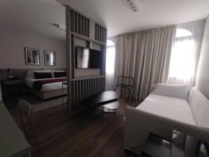 a living room with a couch and a bed at Guemes Hotel & Spa in Salta +55 photos