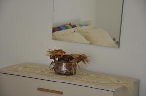 a vase sitting on a table with a mirror at Basilicata Host to Host - Alle Volte in Pisticci