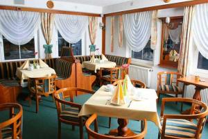 a dining room with tables and chairs and windows at Hotel Rodewisch in Rodewisch +22 photos