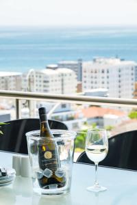 a bottle of wine and a glass on a table at Ocean Vue in Cape Town