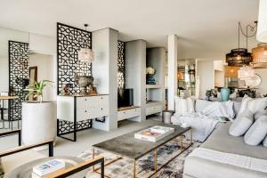 a living room with a couch and a table at Ocean Vue in Cape Town +37 photos