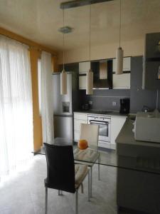 a kitchen with a table and chairs in a room at Art apartment Kiril and Metodi square in Burgas City