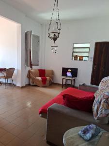 a living room with a couch and a table at Casa Por do Sol in Rio de Janeiro