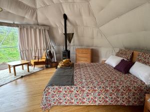 a bedroom with a bed in a tent at Takahuri Glamping Domes in Whanganui