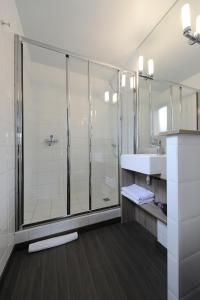 a bathroom with a shower and a sink at Hôtel Beau Soleil in Pornic