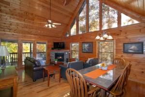 a dining room and living room of a cabin at Bears Corner w/ Hot Tub, Arcade & Community Pool! in Gatlinburg