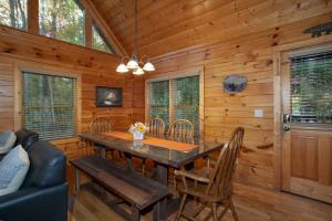 a dining room with a table and chairs in a cabin at Bears Corner w/ Hot Tub, Arcade & Community Pool! in Gatlinburg