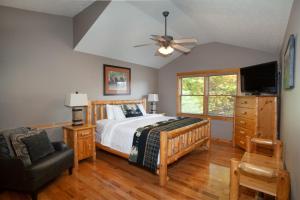 a bedroom with a bed and a ceiling fan at Bears Corner w/ Hot Tub, Arcade & Community Pool! in Gatlinburg