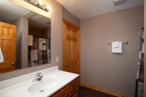 a bathroom with a sink and a mirror at Bears Corner w/ Hot Tub, Arcade & Community Pool! in Gatlinburg +37 photos