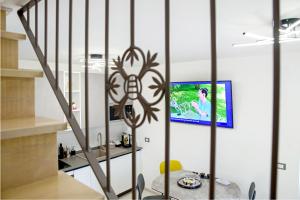a living room with a tv on a wall at Locazione Turistica Arcobaleno "Appartamento Deluxe" in Roccavivara