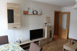 a living room with a flat screen tv on a wall at La Cañada in Candeleda
