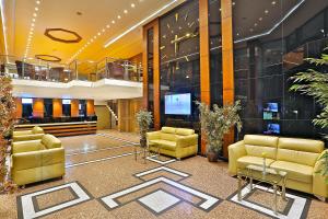 a lobby with couches and a television in a building at Grand Madrid Hotel in Istanbul