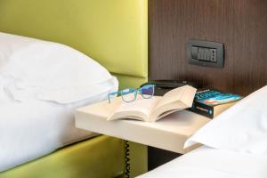Postel nebo postele na pokoji v ubytování Kona Hotel Verona by Kleos Group Collection